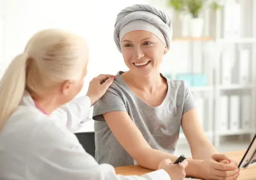 Compassionate dental specialist supporting a cancer patient during a consultation about managing oral health at Legacy Oral Surgery in New York and New Jersey.