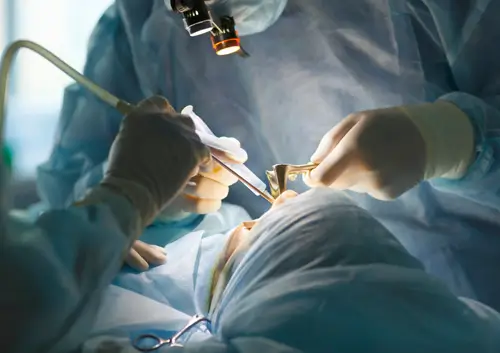 Close-up of a highly skilled surgical team performing a complex oral procedure with specialized equipment at Legacy Oral Surgery in New York and New Jersey.