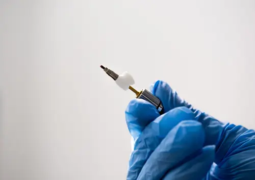 Dentist holding a dental implant tool