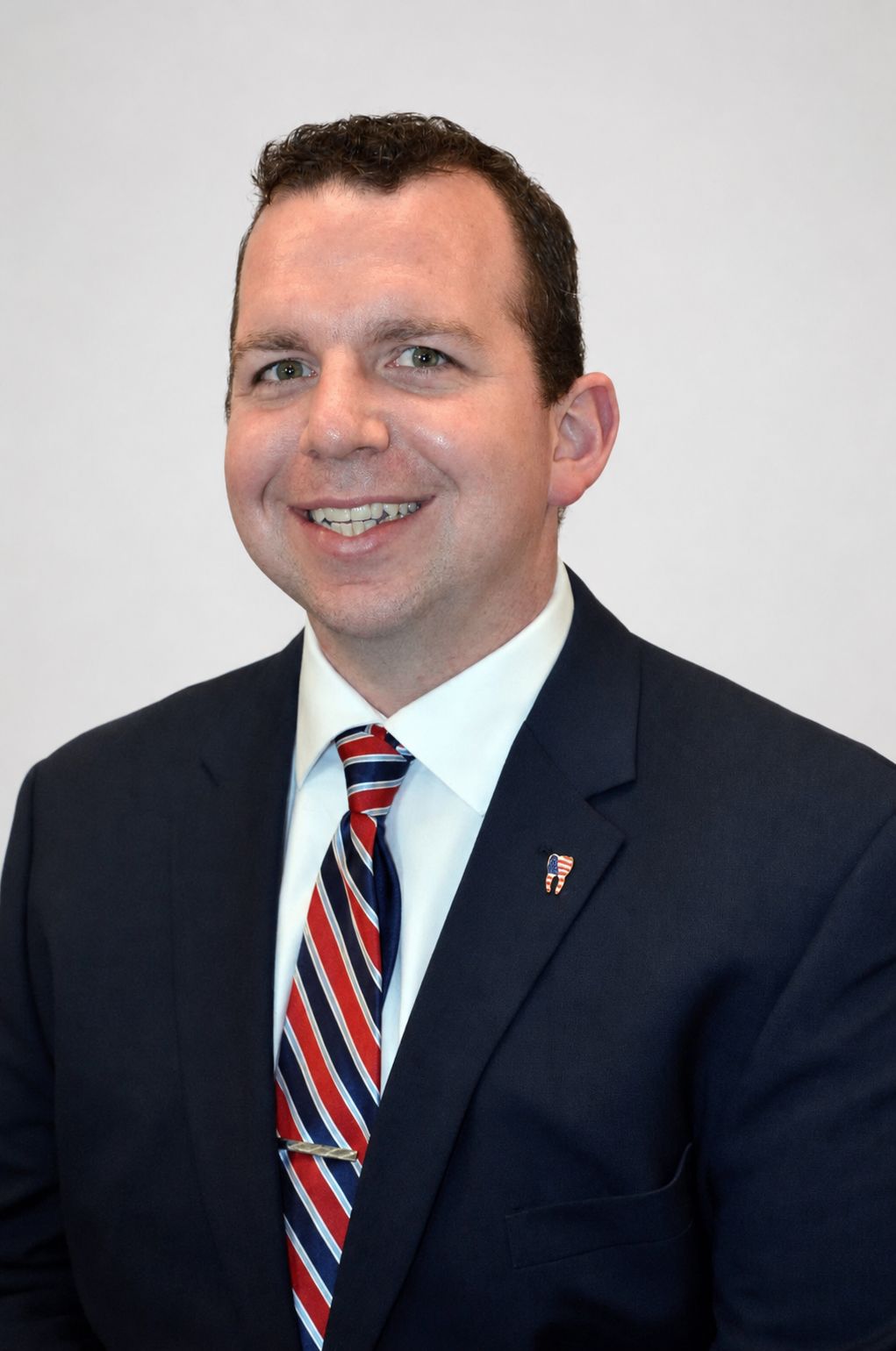 Dr. Dawley smiling in a suit
