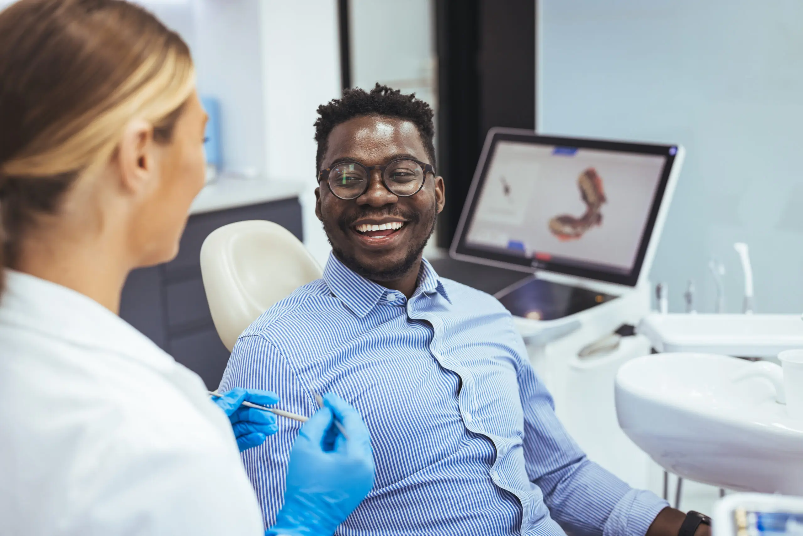 Happy patient discussing his personalized treatment plan with a specialist at Legacy Oral Surgery in New York and New Jersey.