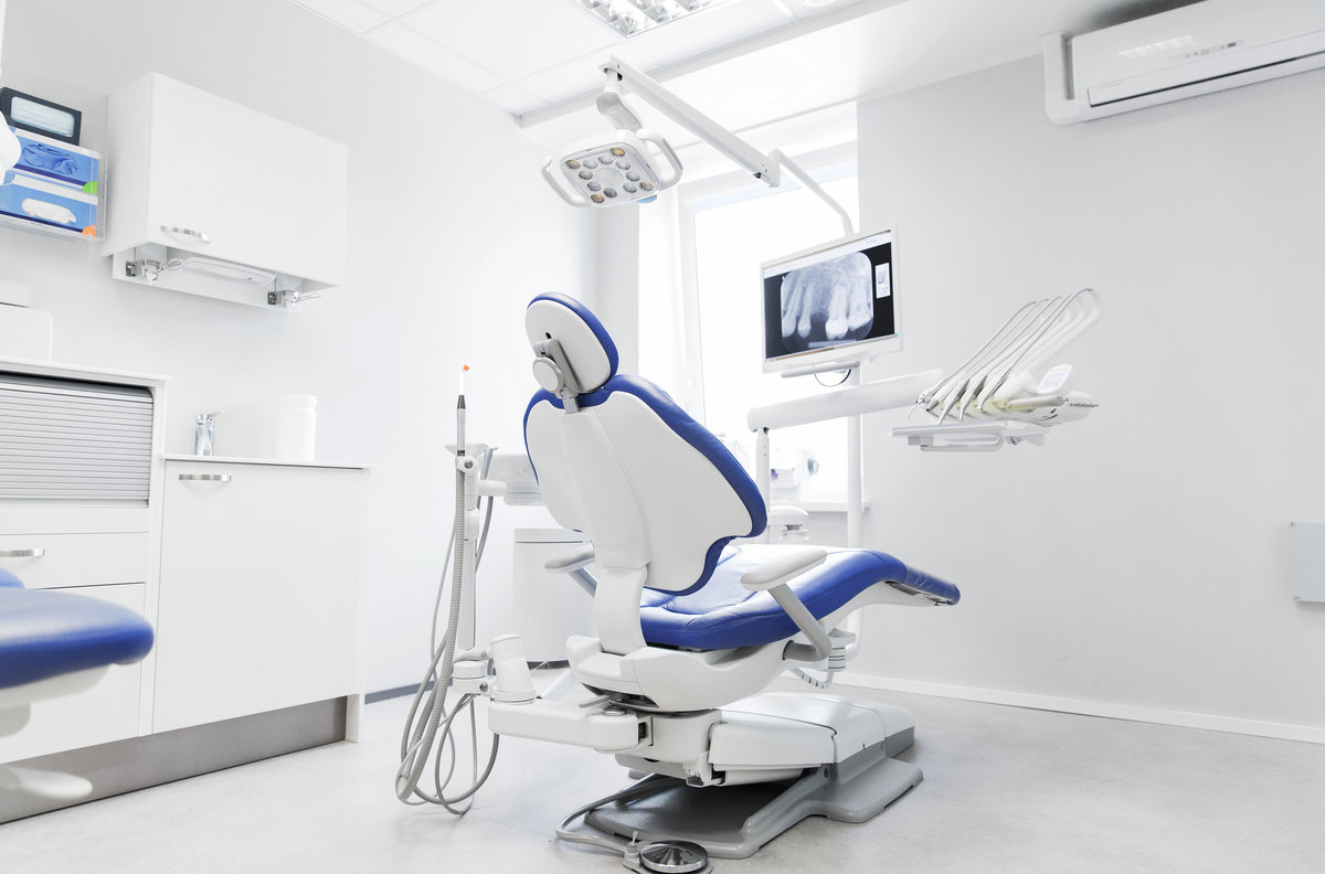 dentistry, medicine, medical equipment and stomatology concept - interior of new modern dental clinic office with chair