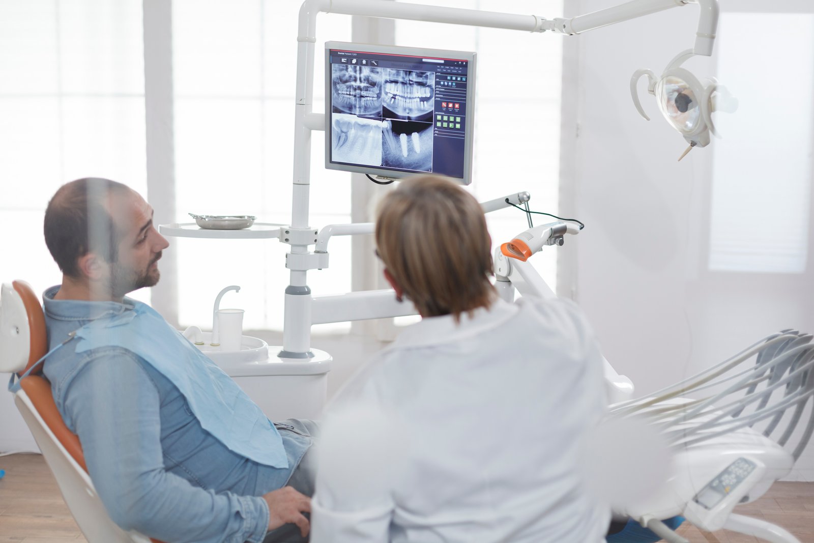 Dental patient discussing wisdom teeth with an oral surgeon during a consultation